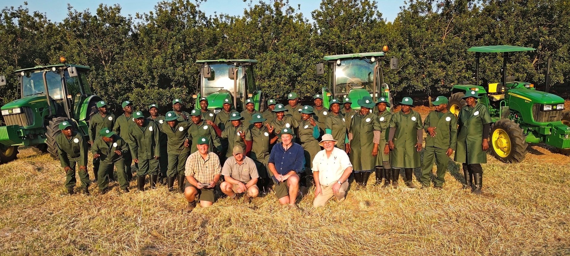 The Sunstone Valley crew and management in front of the tractors at the end of a working day